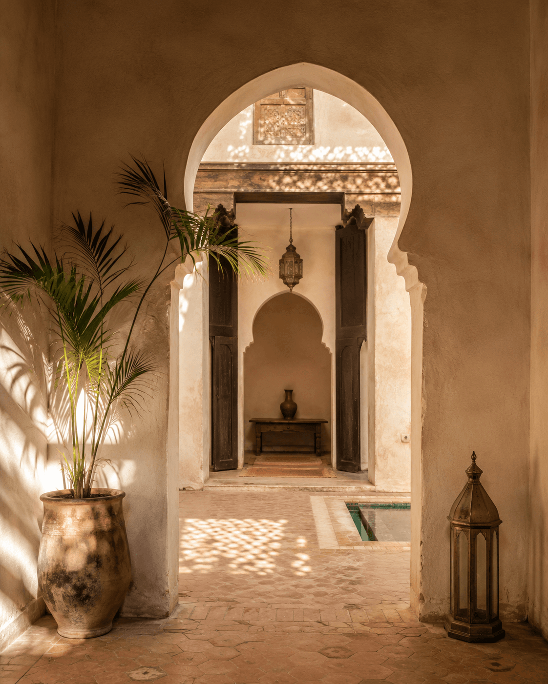 Sunlit keyhole archway in a Marrakech riad courtyard